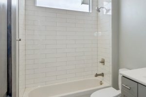 White subway tile in a tub and shower enclosure