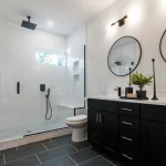 Modern full bathroom remodel with rain shower, new vanity, and quartz countertops.