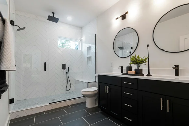 Modern full bathroom remodel with rain shower, new vanity, and quartz countertops.